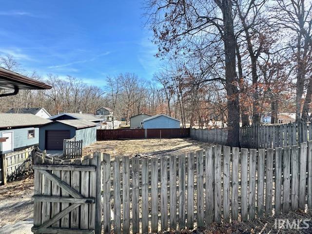 view of yard featuring a fenced front yard and a garage