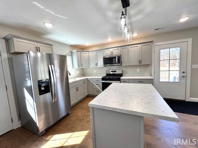 kitchen featuring visible vents, appliances with stainless steel finishes, light countertops, and gray cabinetry