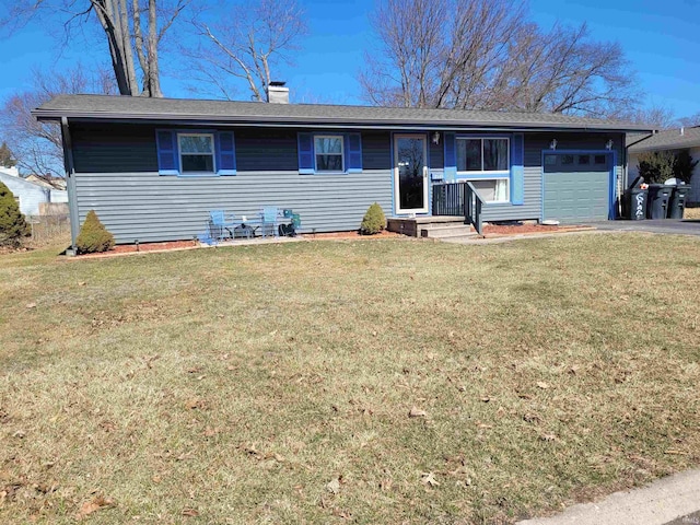 ranch-style house with a front lawn, an attached garage, a chimney, and aphalt driveway