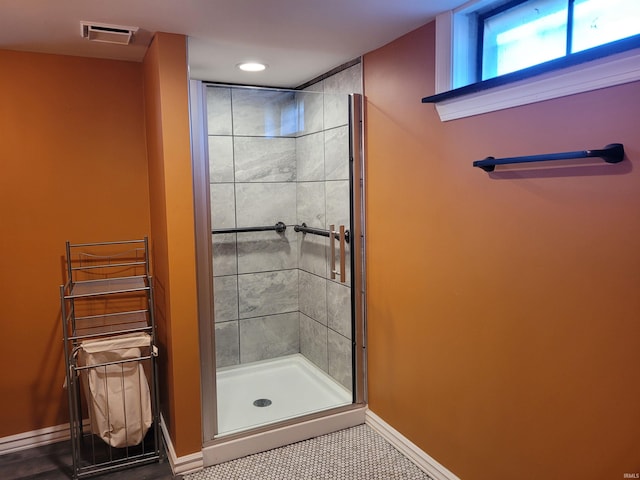 bathroom with tile patterned floors, visible vents, radiator, a shower stall, and baseboards