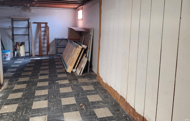 basement with tile patterned floors and concrete block wall