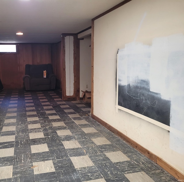 basement featuring tile patterned floors and baseboards