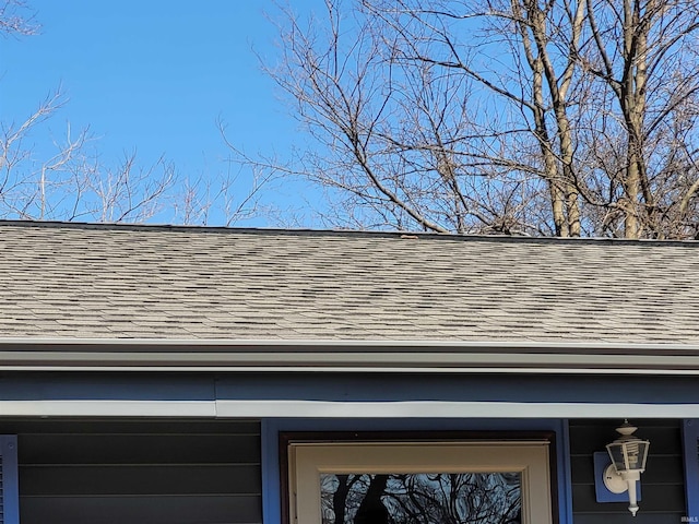 exterior details featuring roof with shingles