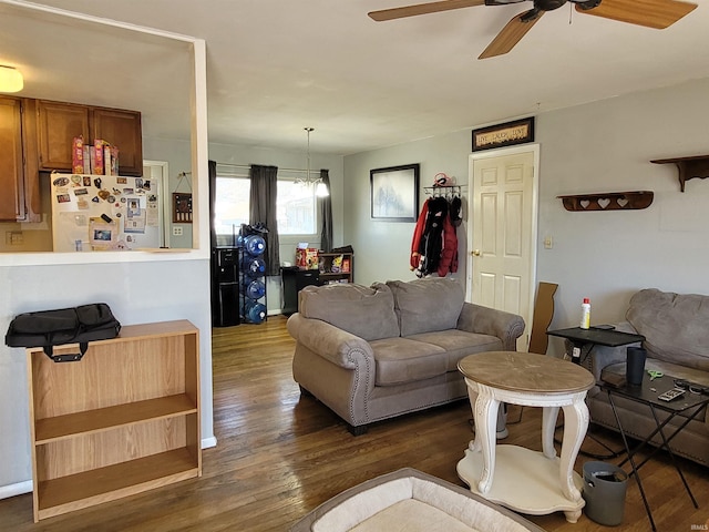 living room with wood finished floors and a ceiling fan