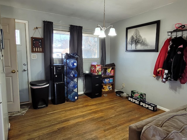 recreation room featuring a chandelier and wood finished floors