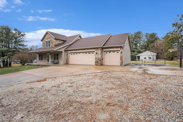 view of front of house featuring stone siding, covered porch, roof with shingles, concrete driveway, and an attached garage