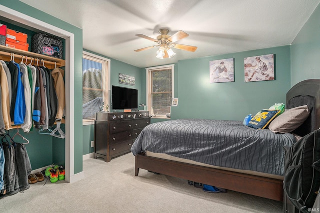 bedroom with baseboards, carpet, a closet, and ceiling fan