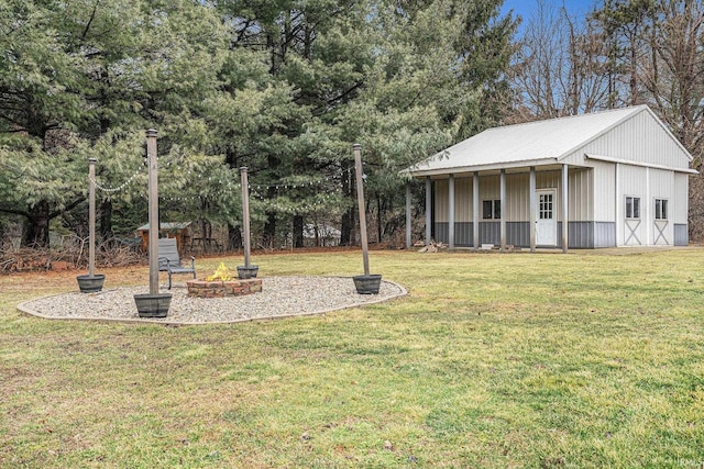 view of yard with an outbuilding and an outdoor fire pit