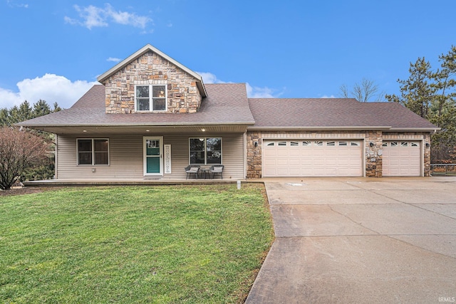 view of front of home featuring driveway, stone siding, an attached garage, and a front yard