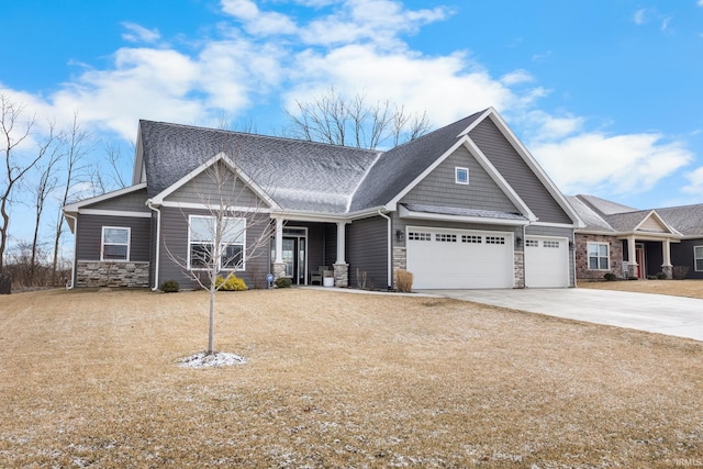 craftsman-style house featuring stone siding, concrete driveway, and an attached garage