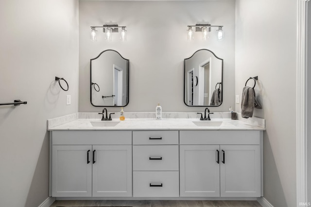 full bath with double vanity and a sink