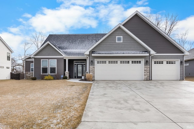 craftsman-style home with stone siding, concrete driveway, a garage, and a shingled roof