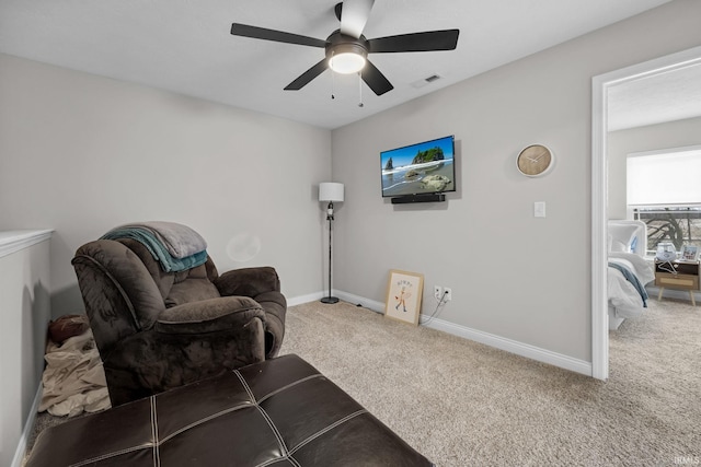 sitting room with visible vents, ceiling fan, baseboards, and carpet floors