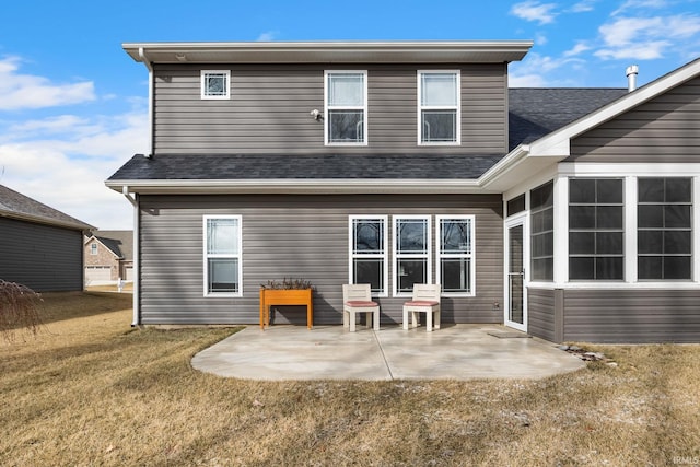 back of property featuring a patio, a lawn, and a shingled roof