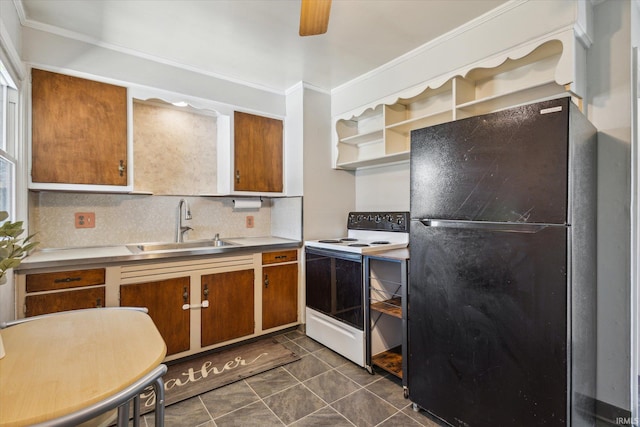 kitchen featuring a sink, brown cabinets, freestanding refrigerator, electric stove, and open shelves