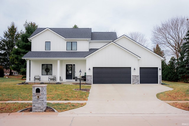 modern farmhouse style home featuring a garage, a porch, concrete driveway, and a front lawn