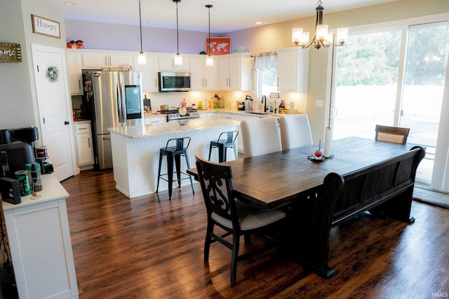 dining area featuring a notable chandelier and dark wood-style flooring