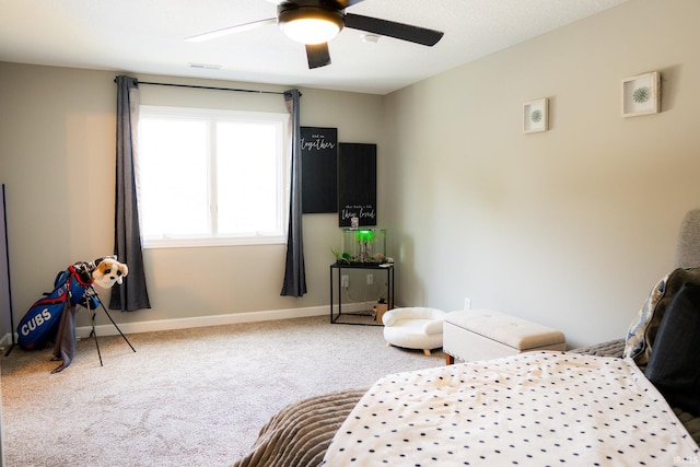 carpeted bedroom with visible vents, a ceiling fan, and baseboards