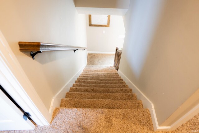 stairs featuring baseboards and carpet floors