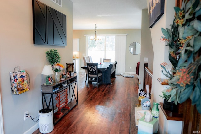 dining space with a notable chandelier, baseboards, dark wood-type flooring, and visible vents