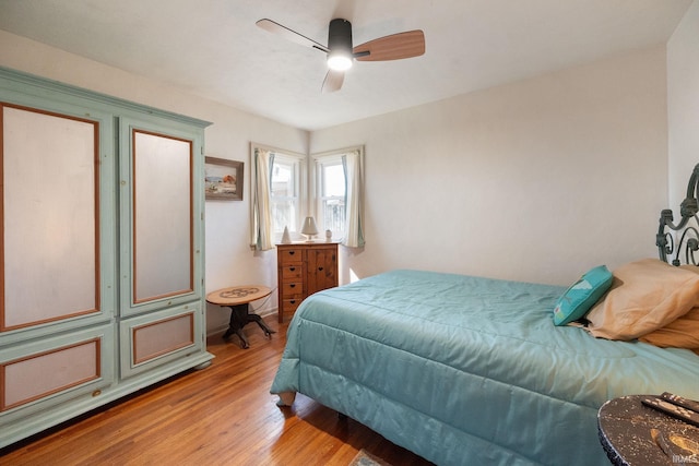 bedroom with ceiling fan and light wood-style floors