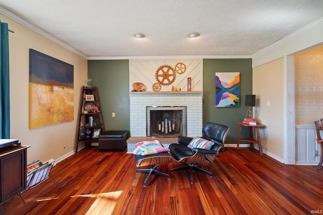 living area featuring a fireplace, wood finished floors, baseboards, and ornamental molding