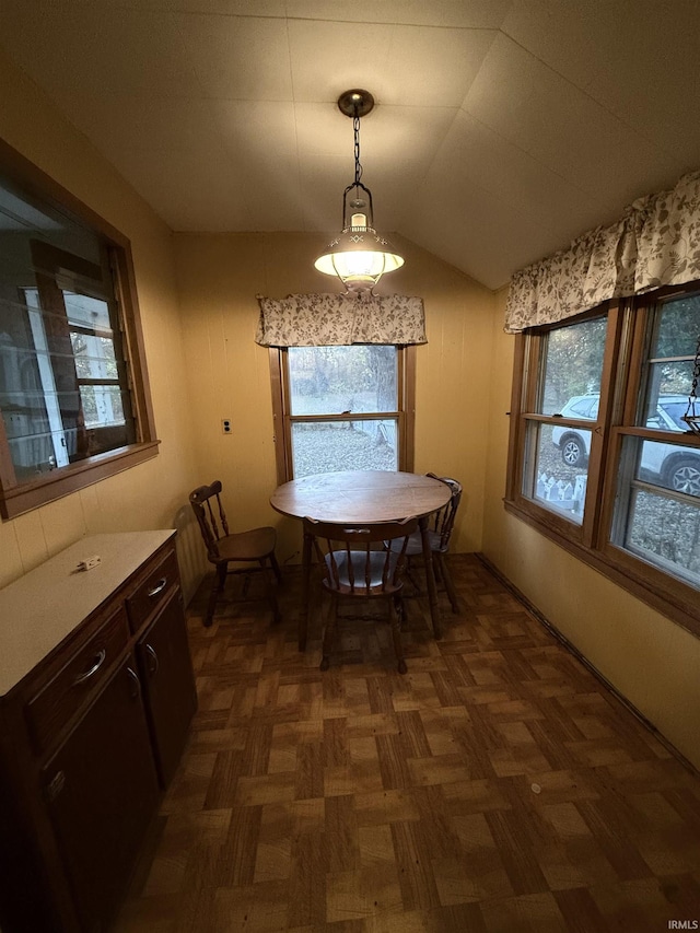 dining space with a wealth of natural light and vaulted ceiling