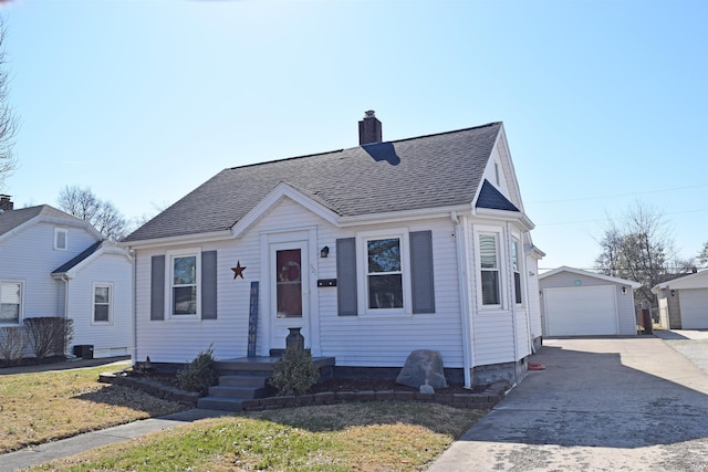 bungalow-style house featuring a chimney, a detached garage, an outdoor structure, and roof with shingles