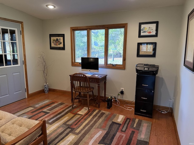 office area with baseboards and wood finished floors