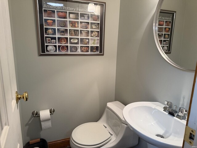 bathroom with toilet and a sink