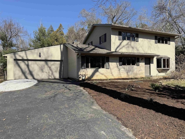 view of front of home featuring aphalt driveway and an attached garage