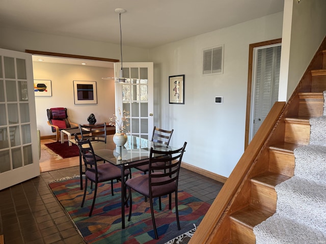 dining room with tile patterned flooring, stairway, french doors, and visible vents