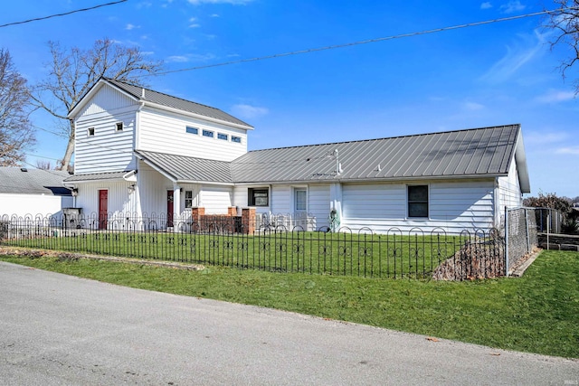 view of front of house featuring a fenced front yard, metal roof, and a front yard