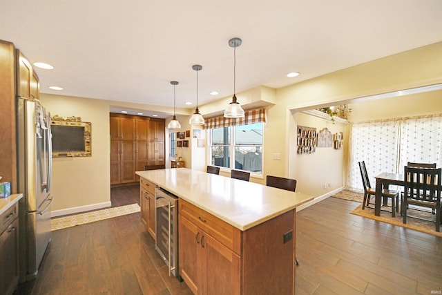 kitchen featuring brown cabinetry, beverage cooler, and dark wood-style flooring