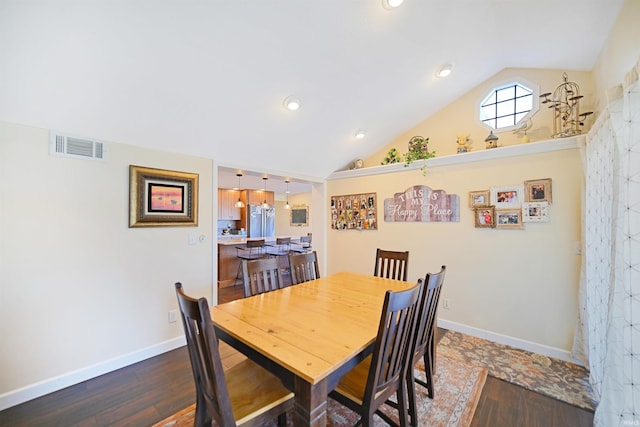 dining space with visible vents, lofted ceiling, dark wood-type flooring, and baseboards