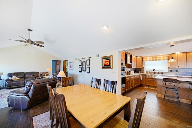 dining area with visible vents, lofted ceiling, ceiling fan, and dark wood-style flooring