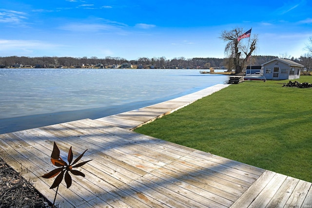 view of dock featuring a yard and a water view