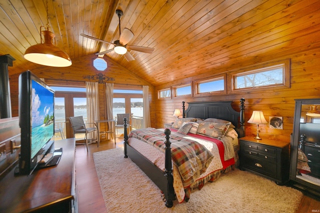 bedroom with multiple windows, wood walls, wooden ceiling, and vaulted ceiling