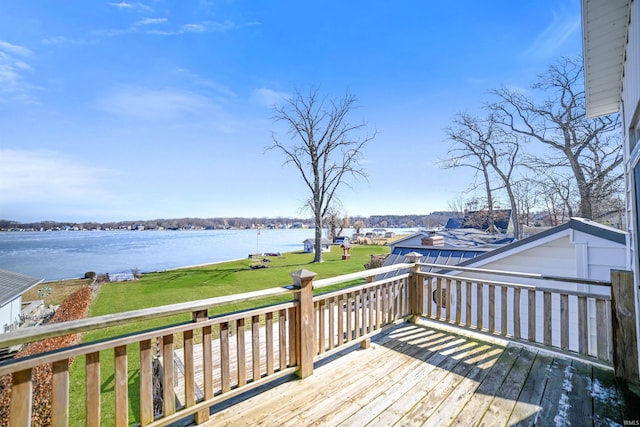 wooden deck featuring a yard and a water view