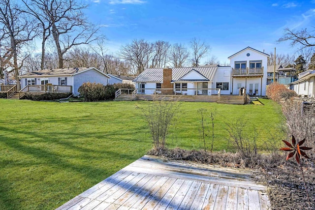 exterior space with a wooden deck and a lawn