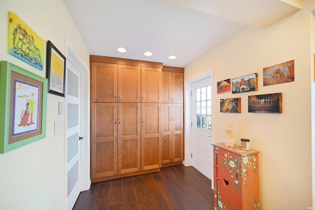 hallway featuring dark wood finished floors and recessed lighting