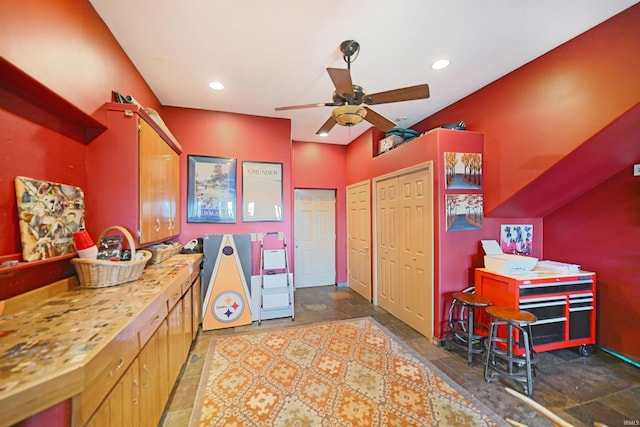 kitchen featuring a ceiling fan, stone tile floors, and recessed lighting