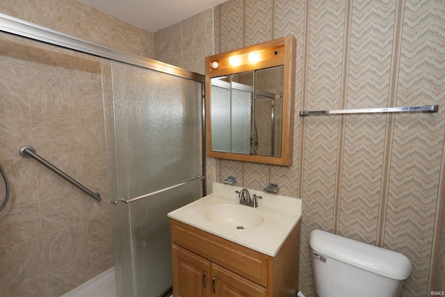 full bath with toilet, tiled shower, and vanity