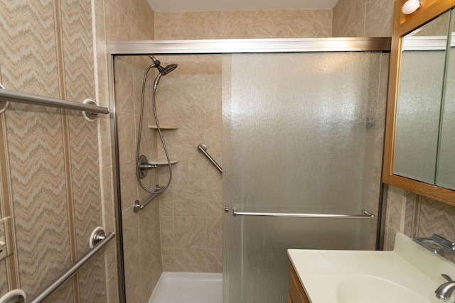 full bath featuring vanity and a shower stall