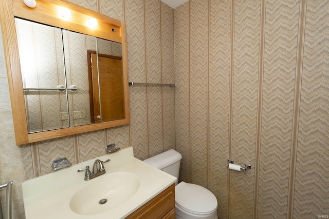 bathroom featuring toilet and vanity