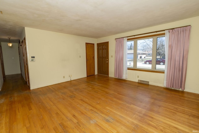 spare room with visible vents and light wood finished floors