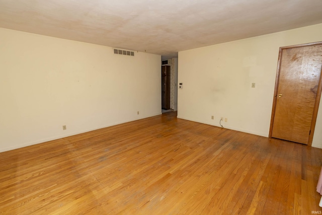 unfurnished room featuring visible vents and light wood-type flooring