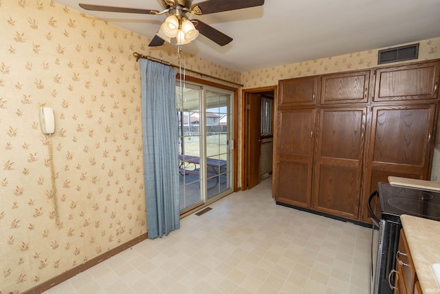 office space with visible vents, baseboards, light floors, and wallpapered walls