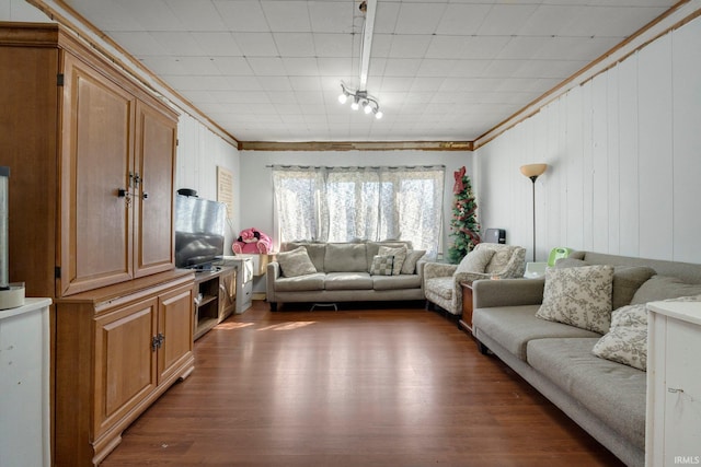 living area featuring wood finished floors and crown molding