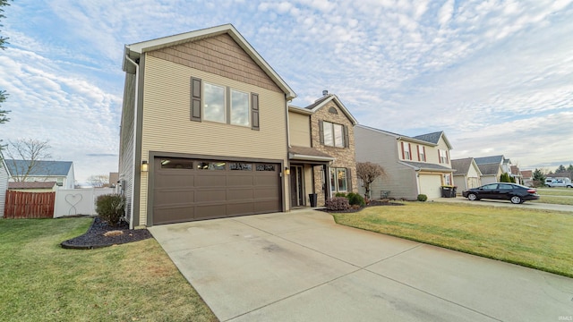 traditional-style home featuring a garage, concrete driveway, a front yard, and fence